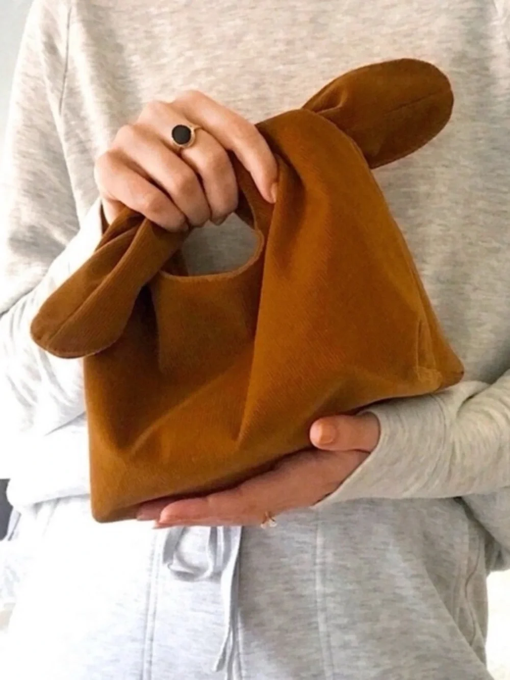 Merit Beauty corduroy knot-top makeup pouch